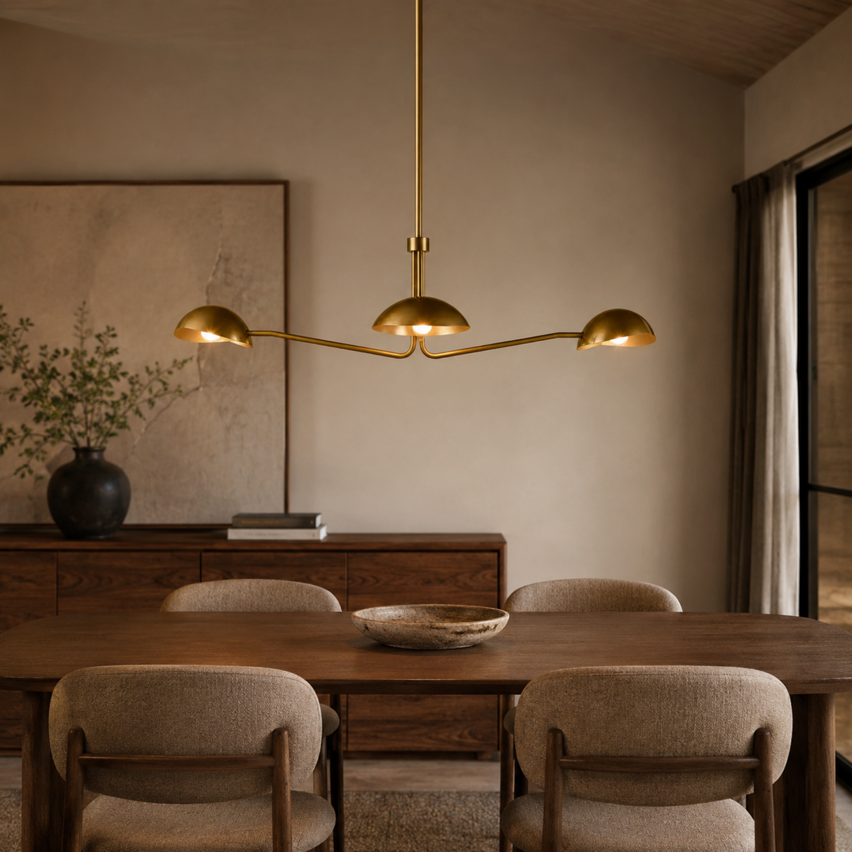 Dining room with a gold chandelier, wooden table, and chairs.