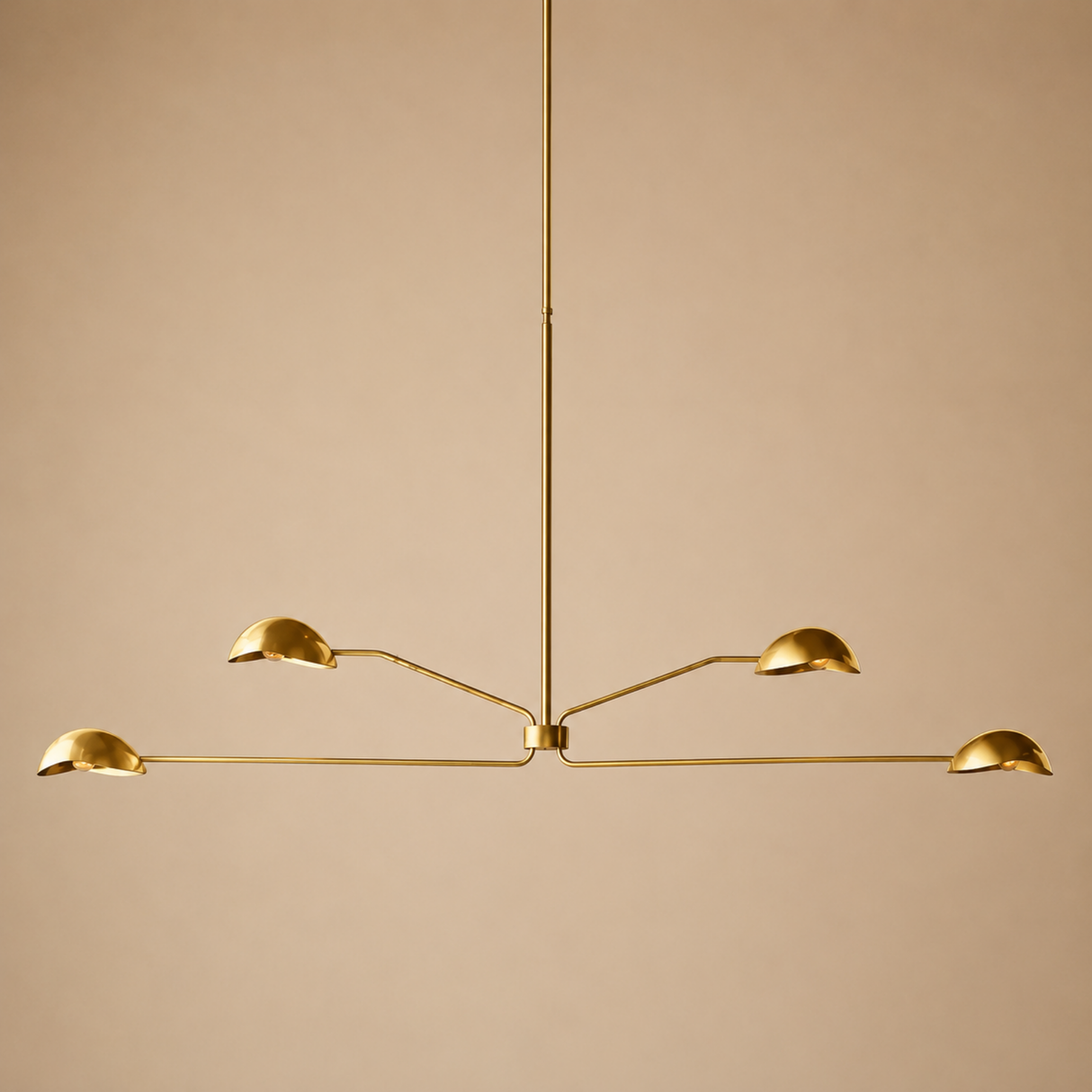 Gold pendant light fixture on a beige background