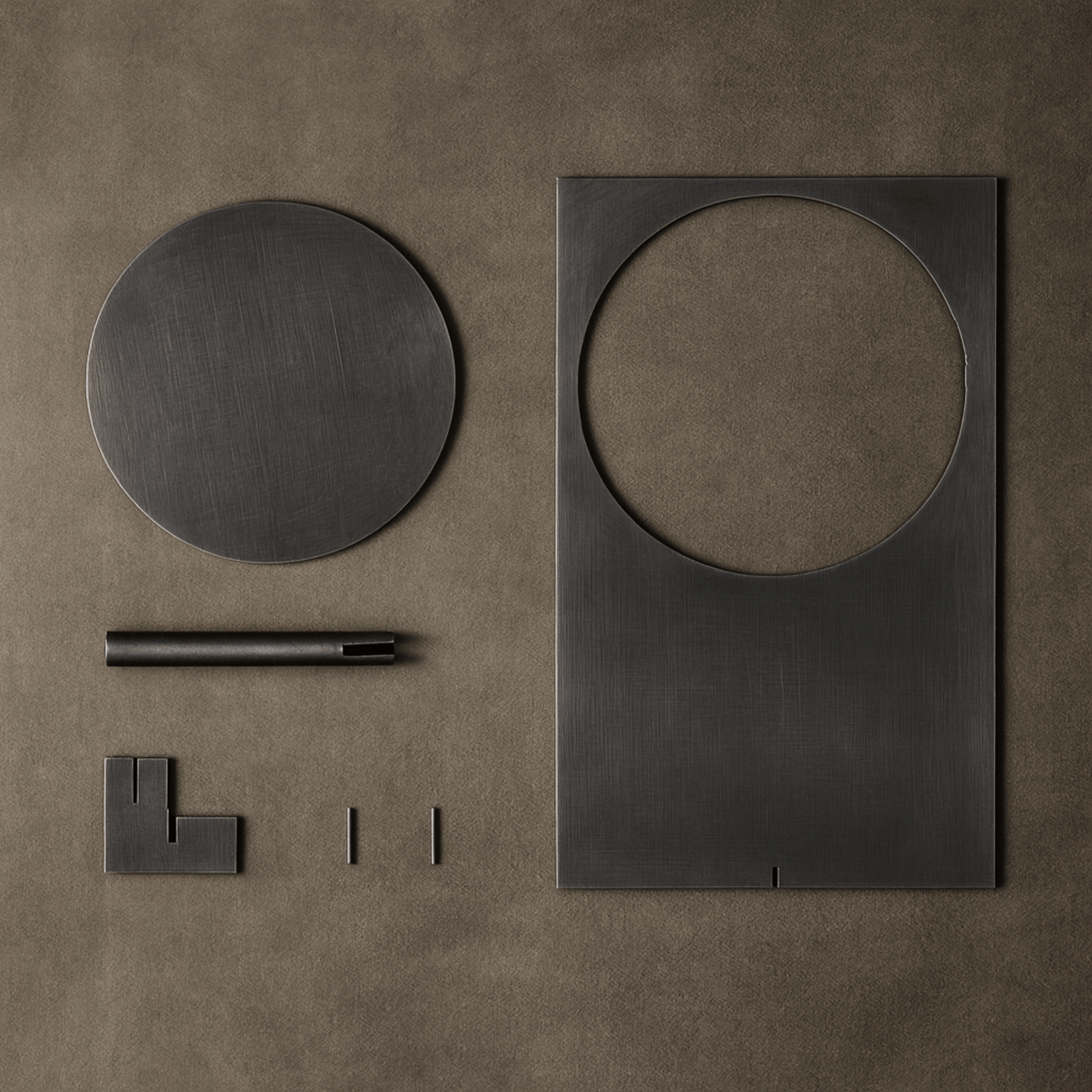 Set of black metal geometric shapes on a brown surface