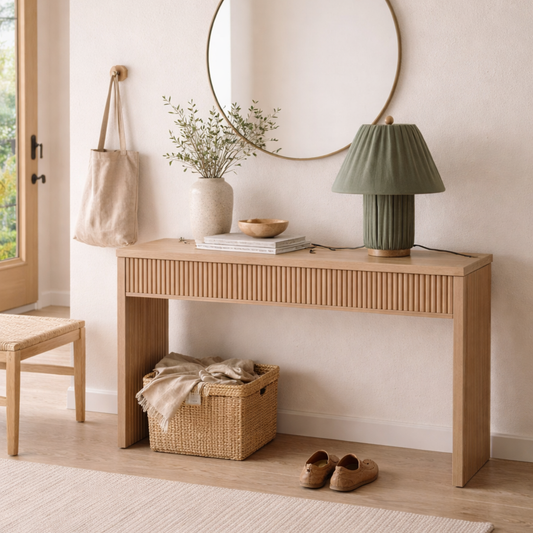 Wooden console table with decorative items in a room with a window and rug.