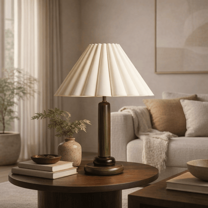 Lamp on a wooden table in a living room setting with a couch and decor.