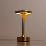 Gold table lamp on a neutral background