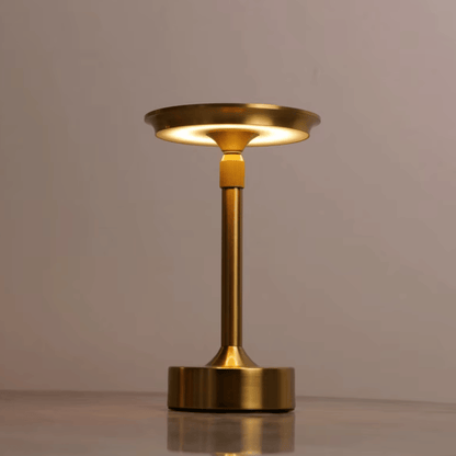 Gold table lamp on a neutral background