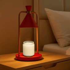 Modern table lamp with red cone-shaped shade and gold accents on a beige background