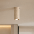 Cylindrical concrete ceiling light fixture on a neutral background