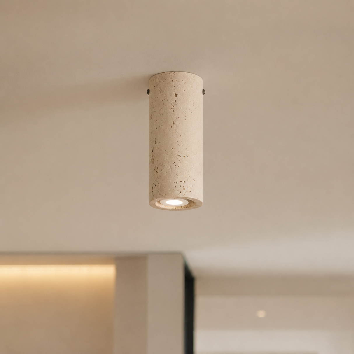 Cylindrical concrete ceiling light fixture on a neutral background