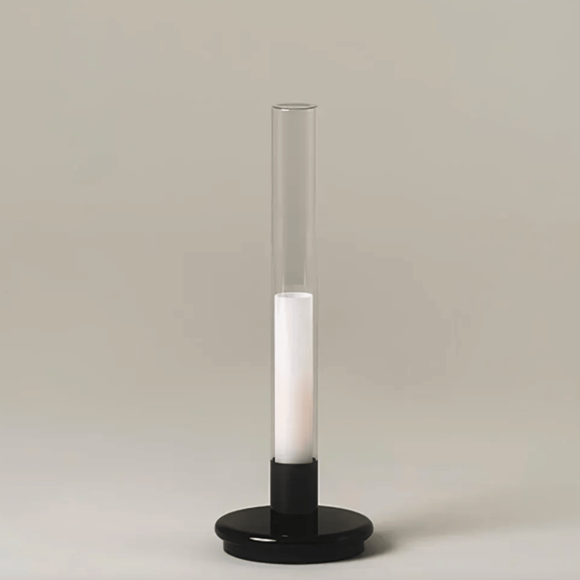 Tall cylindrical light fixture with a white candle-like center on a beige background