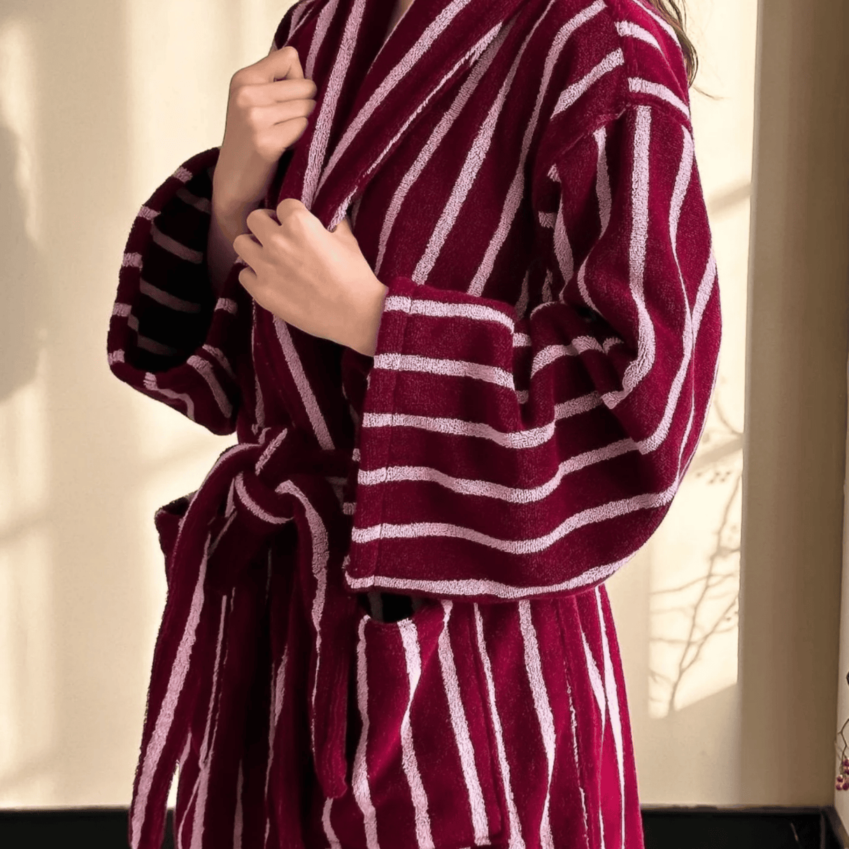 Maroon and white striped robe being worn by a person.