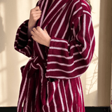 Maroon and white striped robe being worn by a person.