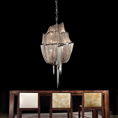 Decorative chandelier hanging above a wooden dining table with chairs.