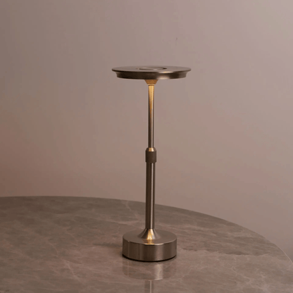 Bronze-colored lamp on a gray surface with a neutral background