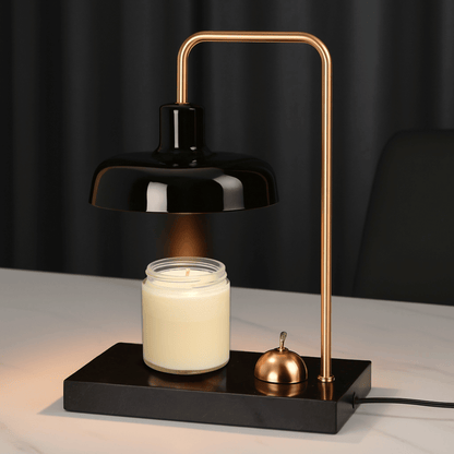Modern desk lamp with black shade and gold arm on a white background
