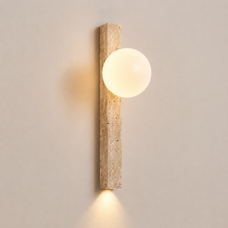 Wall-mounted light fixture with a cylindrical wooden casing and round glass shade on a neutral wall.