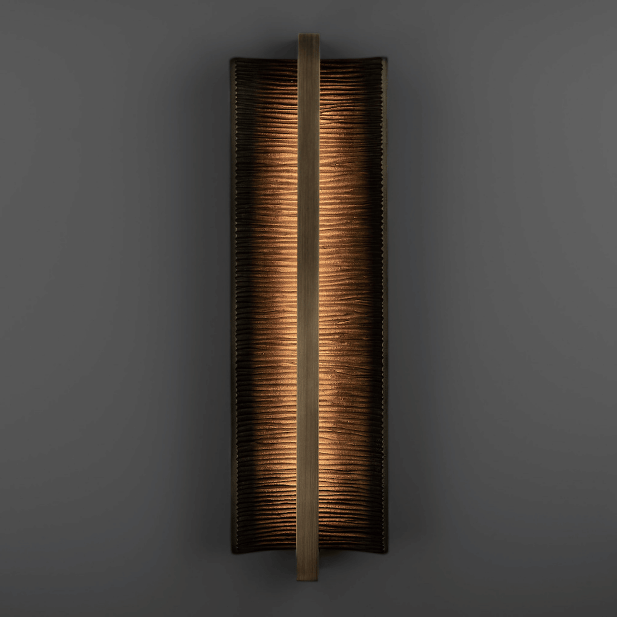 Rectangular wall sconce with a textured finish on a dark background