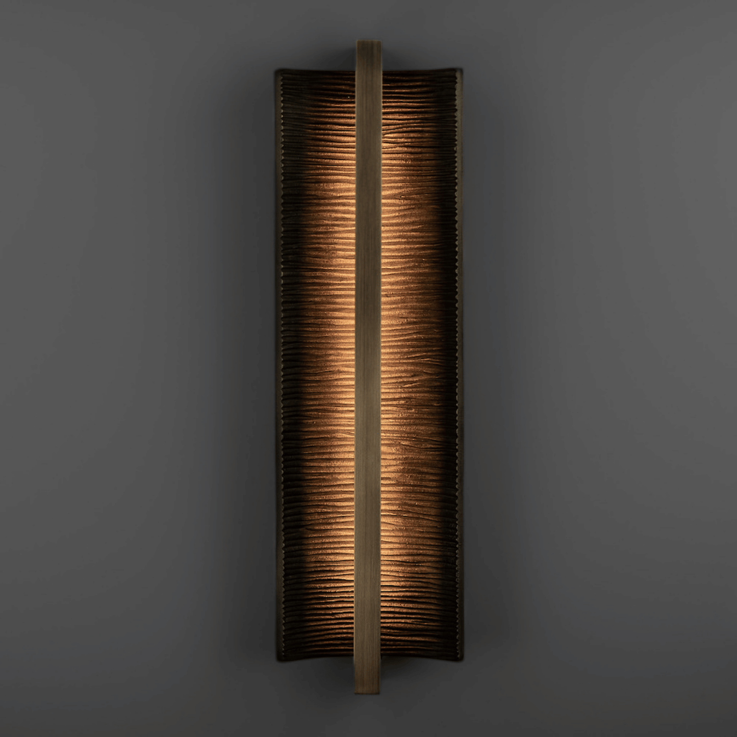 Rectangular wall sconce with a textured finish on a dark background
