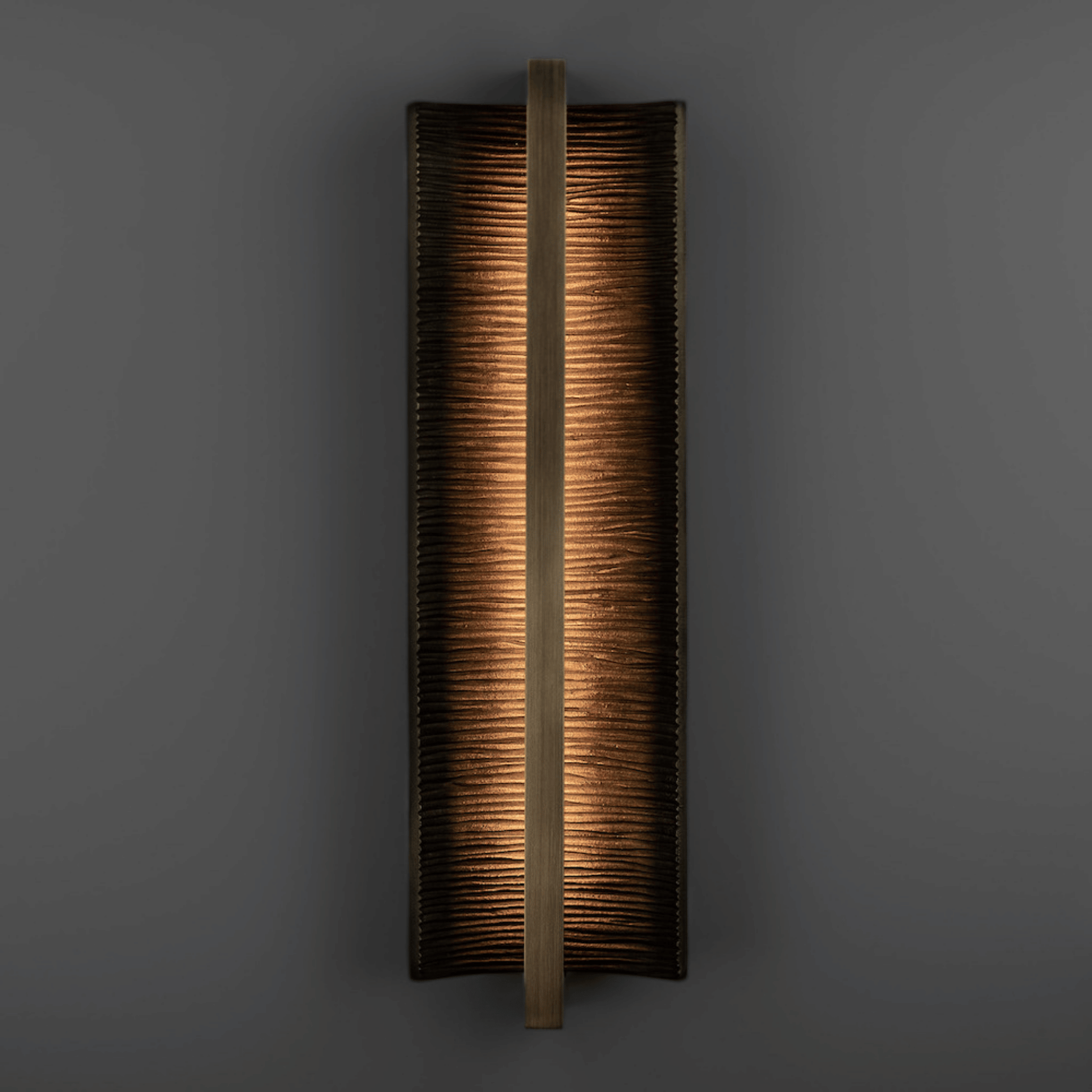 Rectangular wall sconce with a textured finish on a dark background
