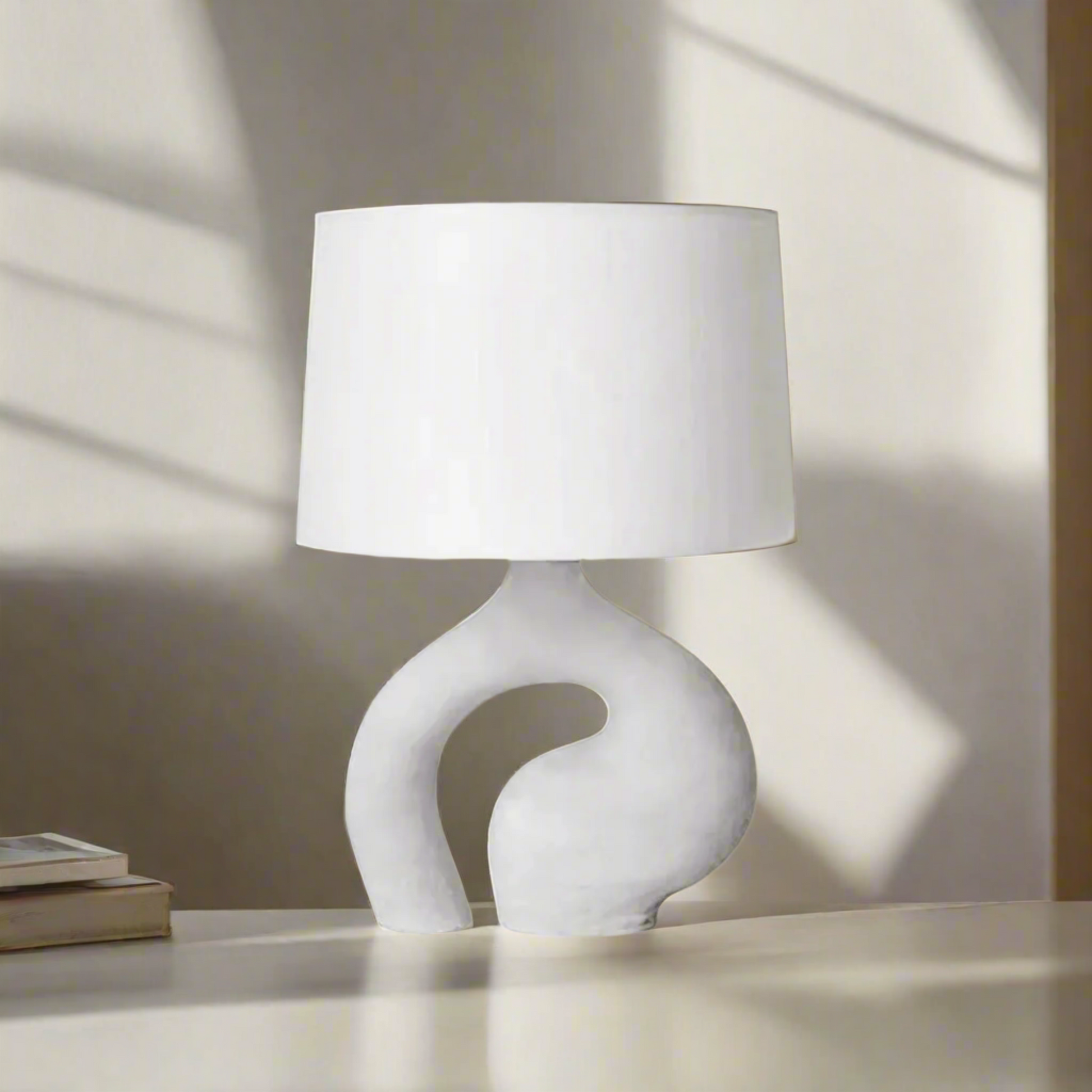 White table lamp with a unique base design on a white background
