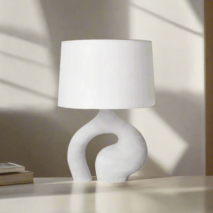 White table lamp with a unique base design on a white background
