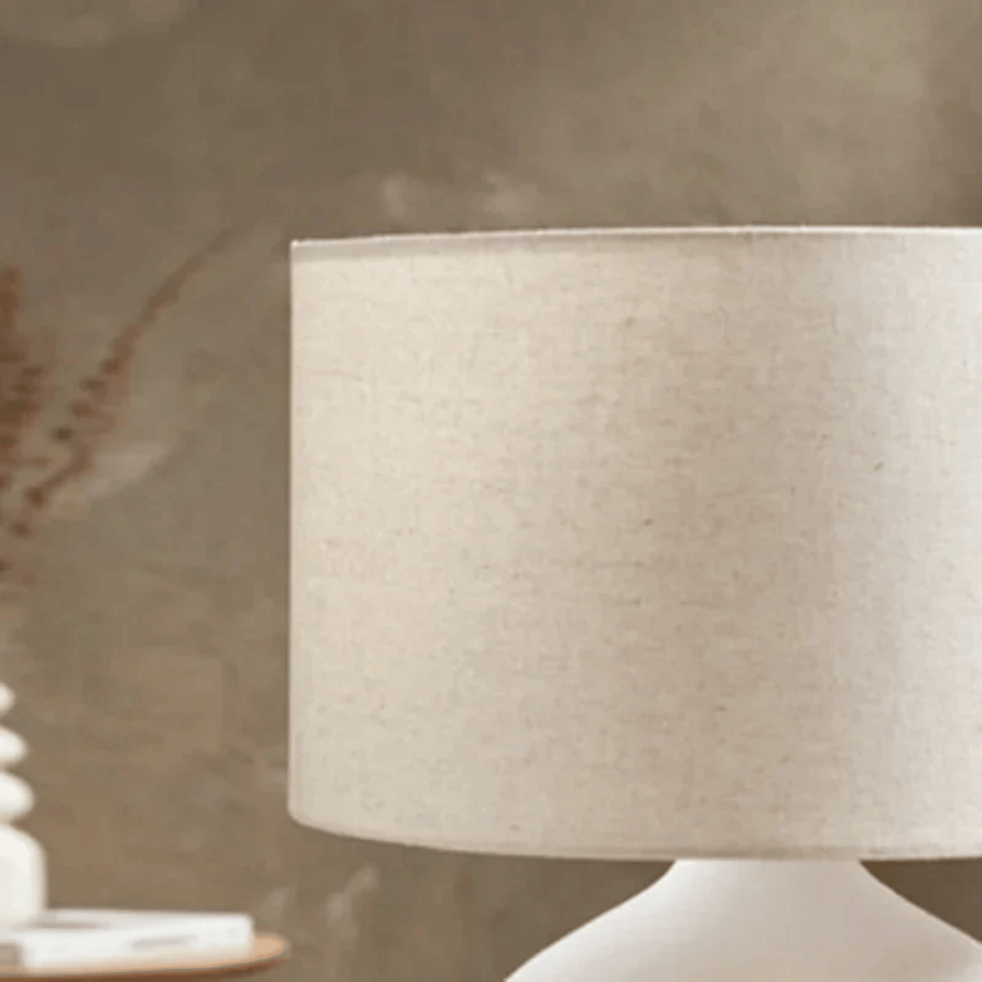 Close-up of a beige lampshade on a neutral background
