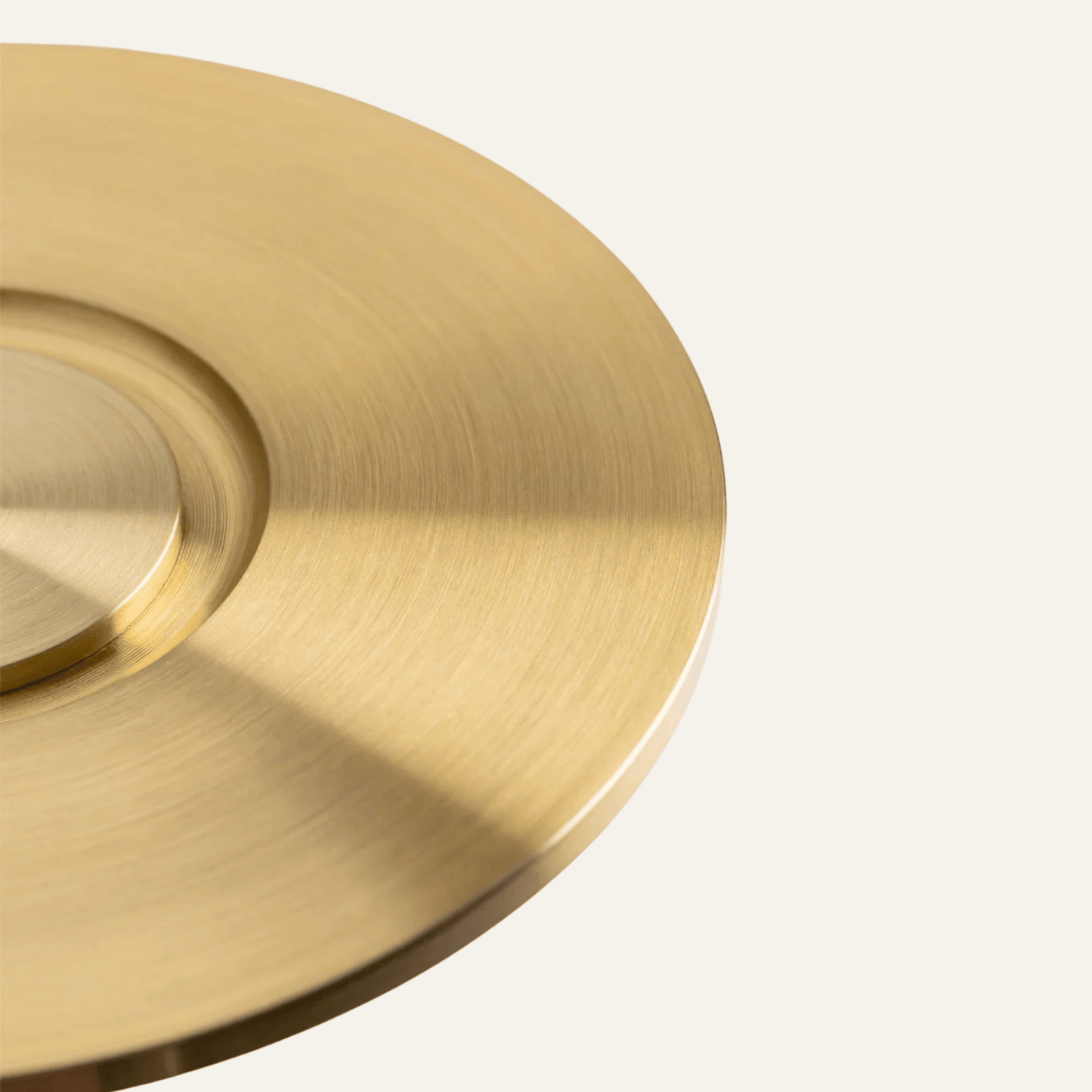 Close-up of a gold circular object on a light gray background