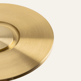 Close-up of a gold circular object on a light gray background