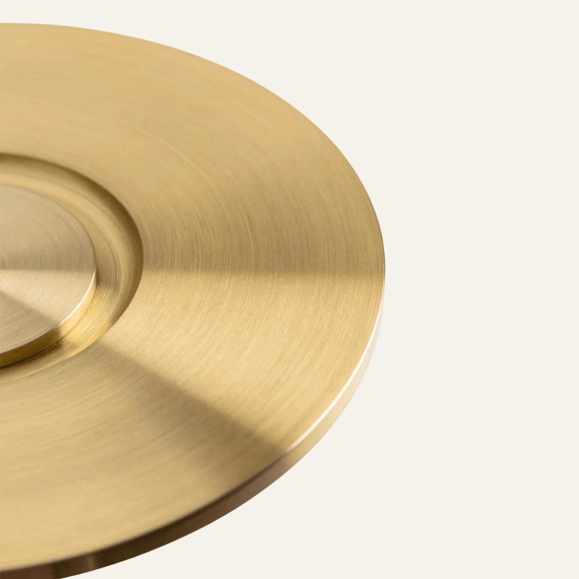 Close-up of a gold circular object on a light gray background