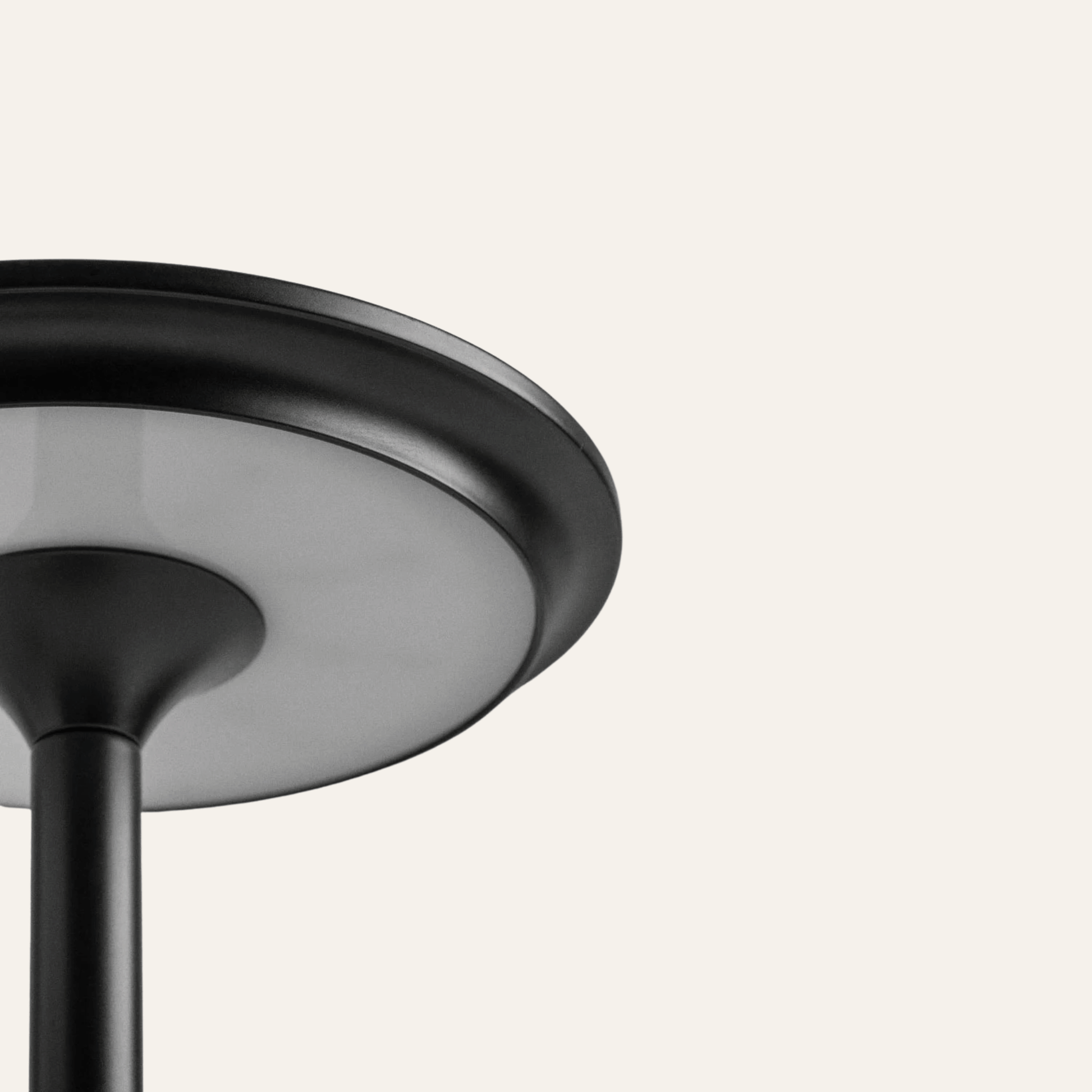 Close-up of a black ceiling light fixture on a white background