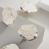 Close-up of textured stone-like cookies on a light background
