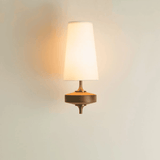 Wall-mounted lamp with a warm glow on a light background