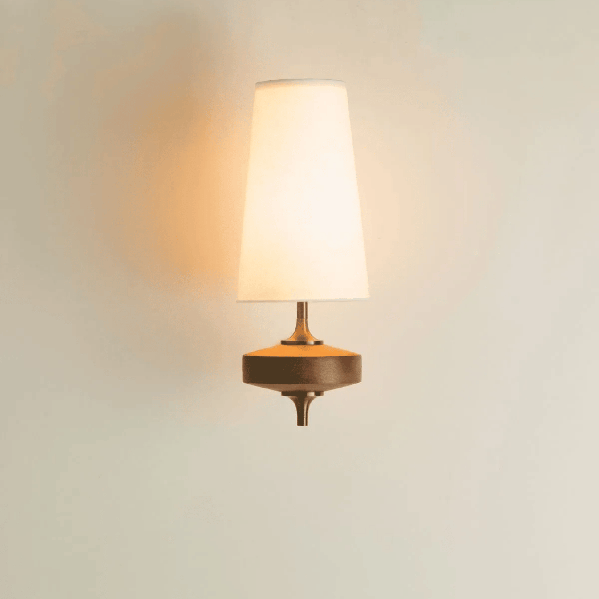 Wall-mounted lamp with a warm glow on a light background