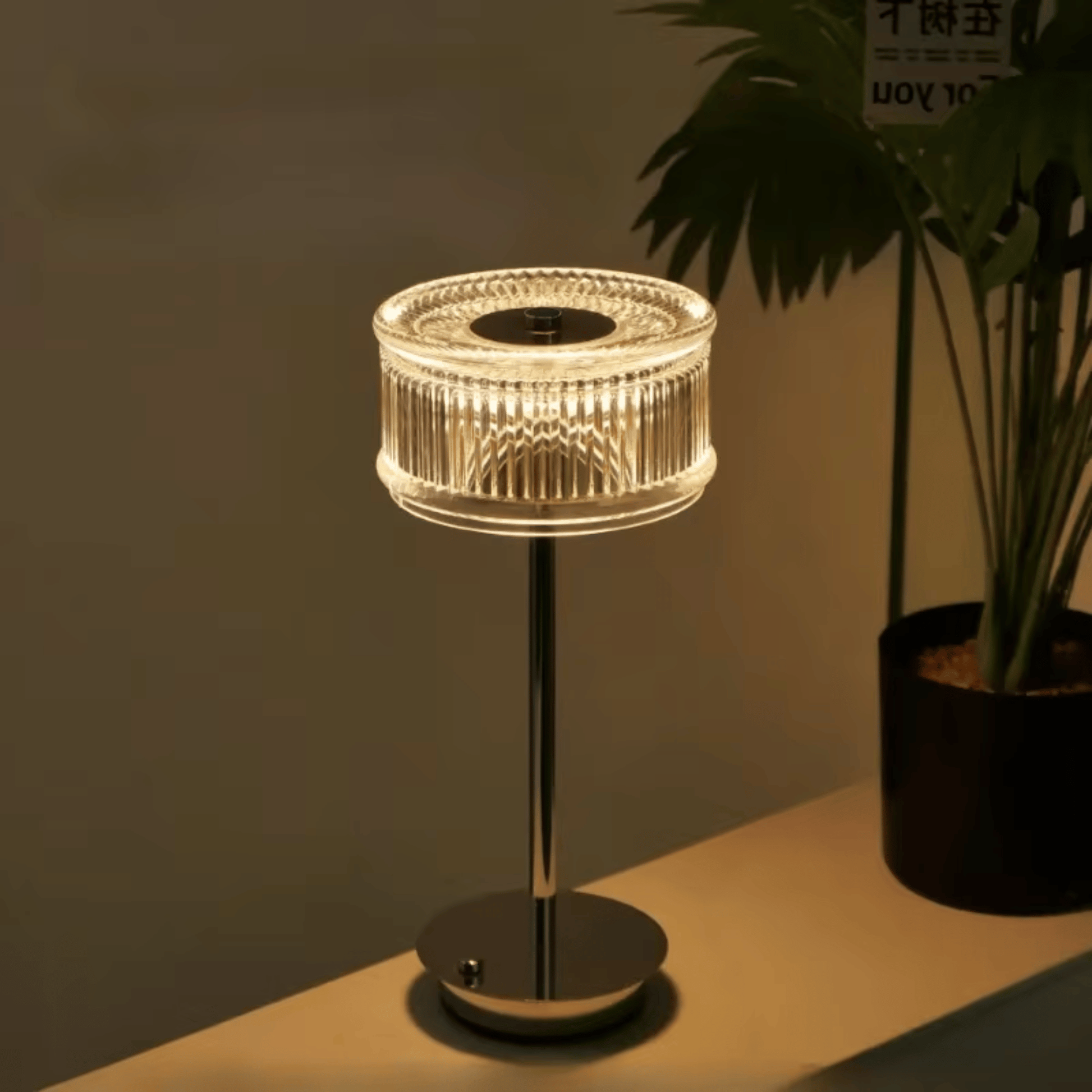 Modern table lamp with a plant on a shelf in a dimly lit room