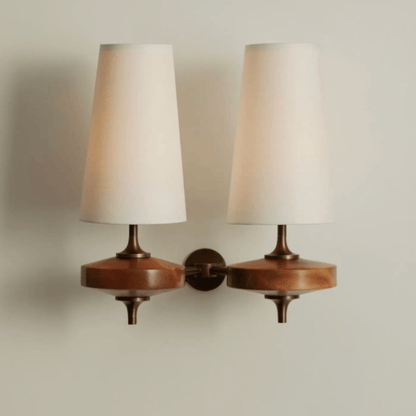 Pair of wall-mounted lamps with wooden bases and white lampshades on a neutral background