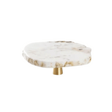 Marble-patterned round object with a gold base on a white background