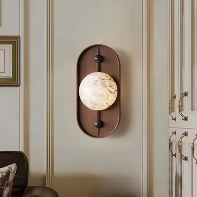 Modern decorative wall sconce mounted in a classic living room interior.