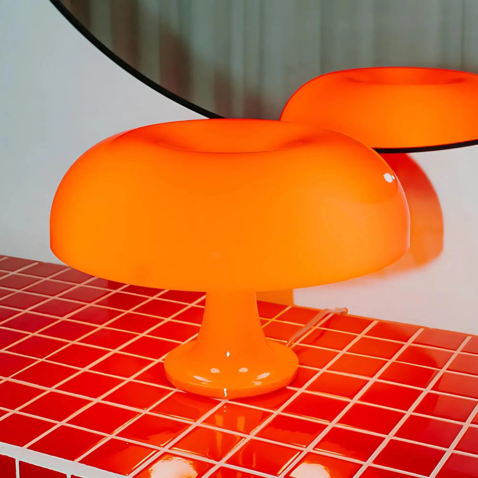 Orange lamp on a red checkered surface with a blurred background

