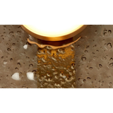 close up of hammered textured metal backplate with warm brass bulb base