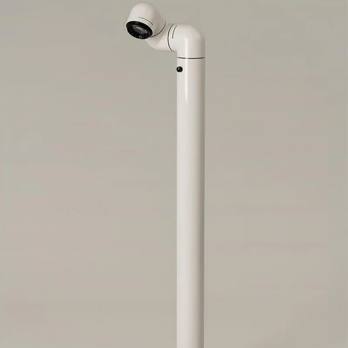 A close-up of a white floor lamp, with its light fixture pointing to a section of the floor.