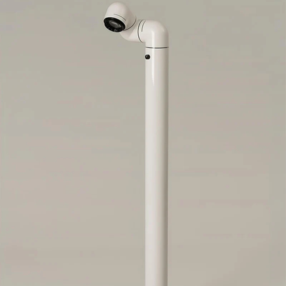 A close-up of a white floor lamp, with its light fixture pointing to a section of the floor.