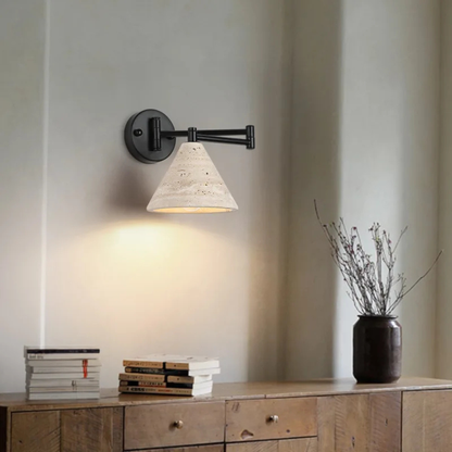 Wall-mounted lamp illuminating a cozy bedroom desk area with warm ambient light.