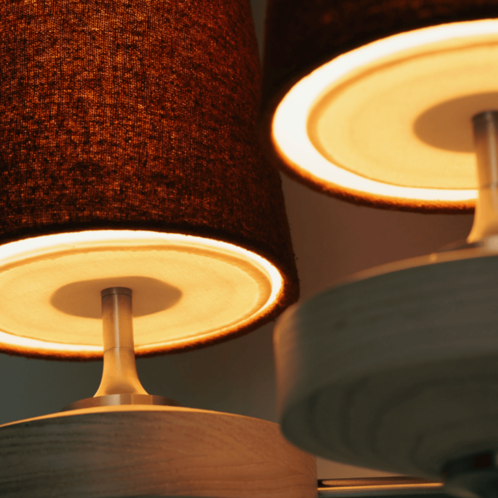 Close-up of a lamp with a textured brown shade and a white base.