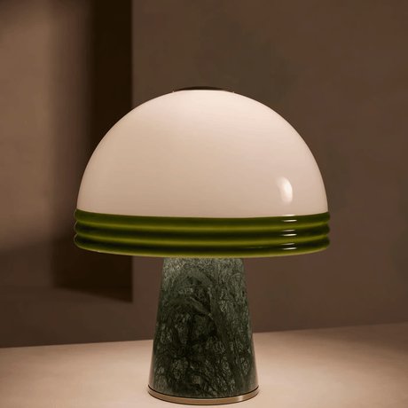 Mushroom-shaped lamp with white top and green base on a neutral background