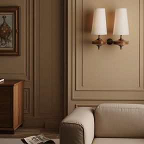 Living room with beige sofa, wooden cabinet, and wall sconces.