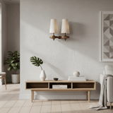 Modern living room with a wooden console table, decorative items, and wall sconces.