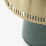 Close-up of a green base with a gold top on a white background