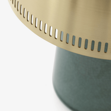Close-up of a green base with a gold top on a white background
