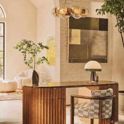 Modern interior with a wooden desk, chair, and decorative elements.