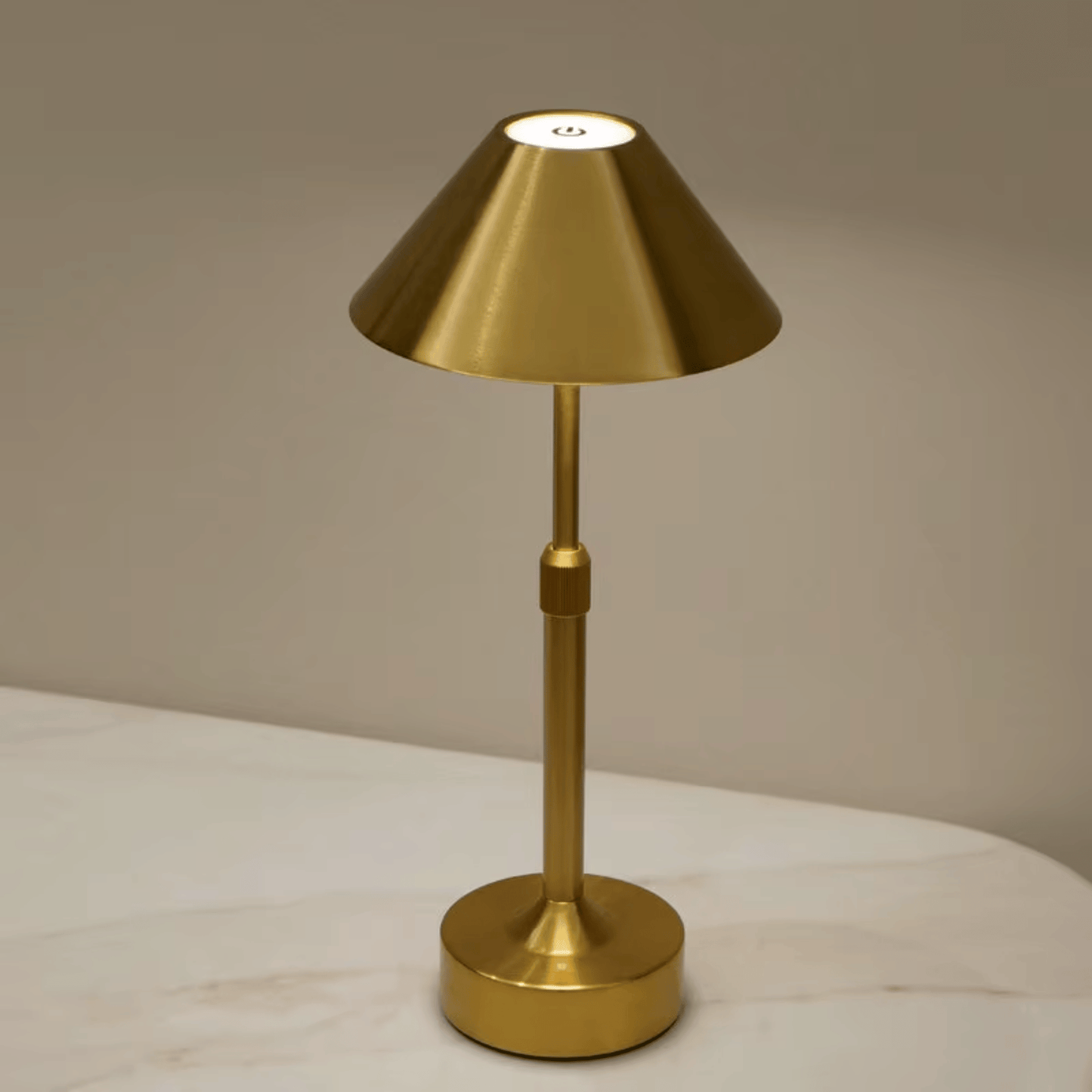 Gold table lamp on a neutral background