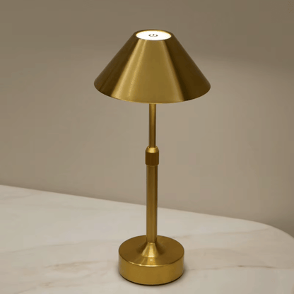 Gold table lamp on a neutral background