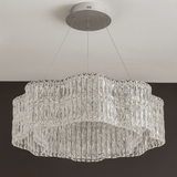 Crystal chandelier hanging from the ceiling against a neutral background