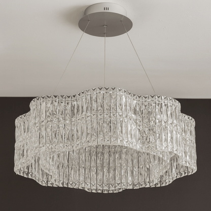 Crystal chandelier hanging from the ceiling against a neutral background